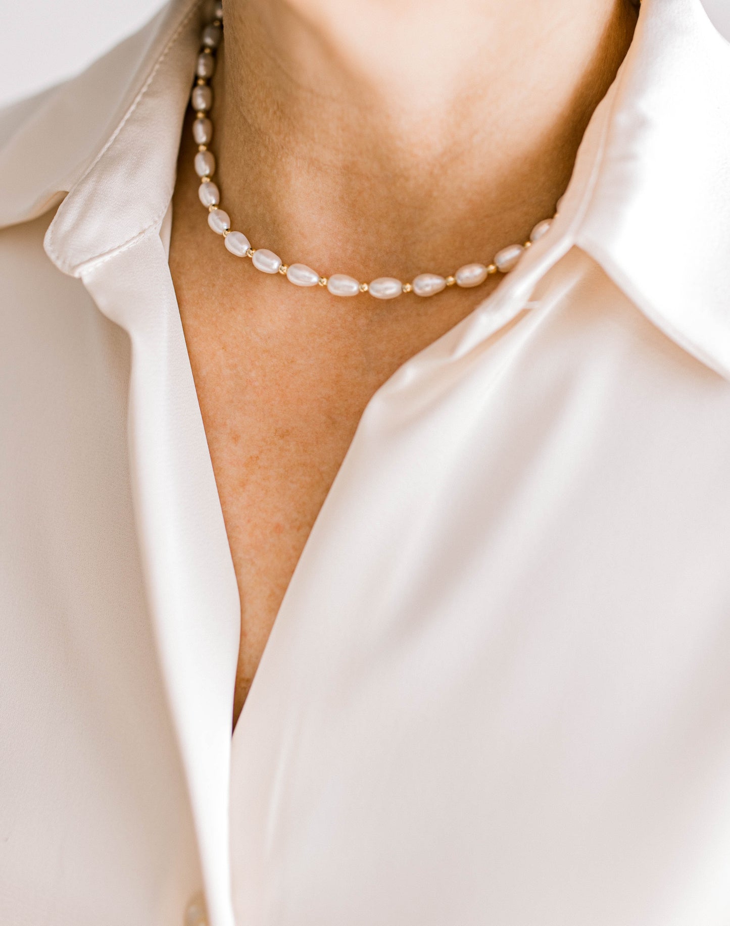 From coastal cowgirl to coastal grandma, this necklace is stunning for all! Beautiful 7-8mm rice shaped freshwater pearls and 3mm gold filled beads These pearls have a high luster and are uniform in size. Available in 15 inch or 17 inch.