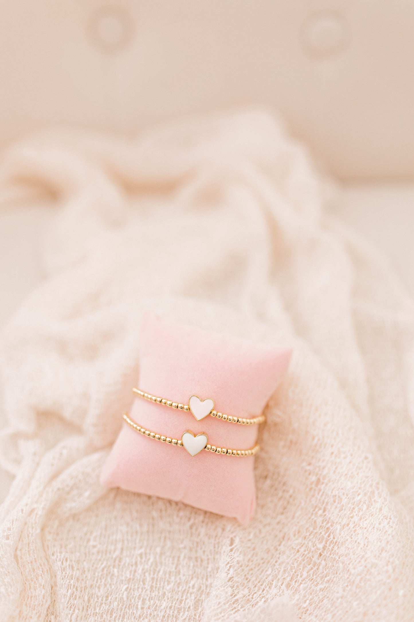 A simple and cute heart bracelet that goes with any outfit, day or night! 3mm 14K gold filled beads with a pink or white heart spacer bead!
