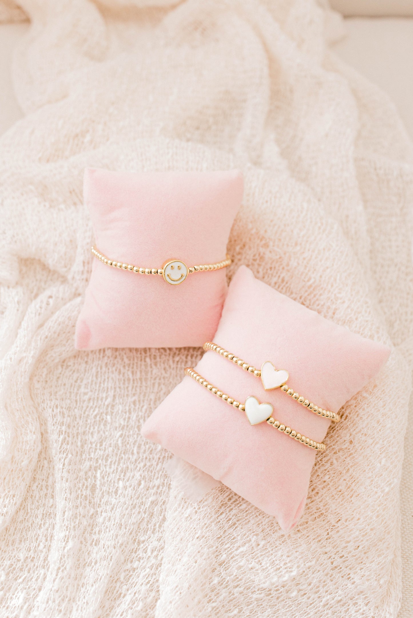 A simple and cute heart bracelet that goes with any outfit, day or night! 3mm 14K gold filled beads with a pink or white heart spacer bead!