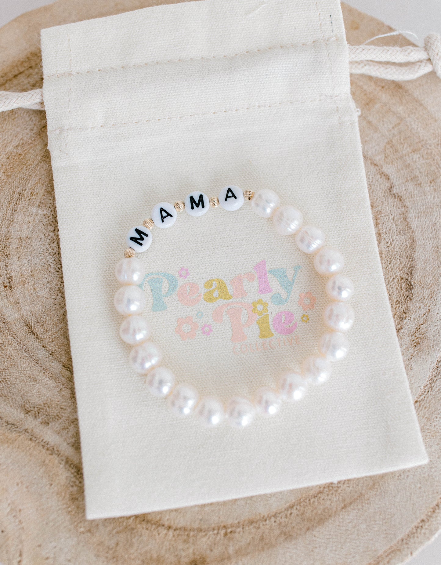 The perfect bracelet for all the mamas out there! This freshwater pearl bracelet can be made with gold letter beads or white letter beads.