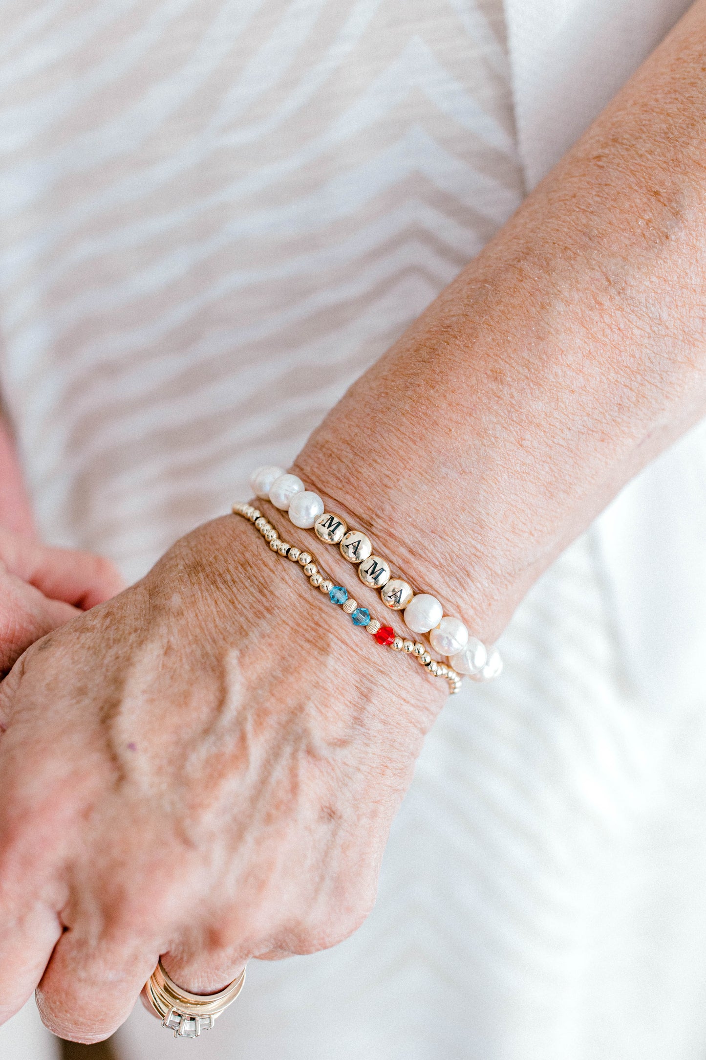 The perfect bracelet for all the mamas out there! This freshwater pearl bracelet can be made with gold letter beads or white letter beads. 