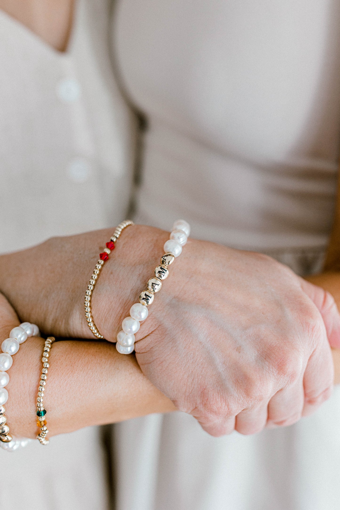 The perfect bracelet for all the mamas out there! This freshwater pearl bracelet can be made with gold letter beads or white letter beads. 