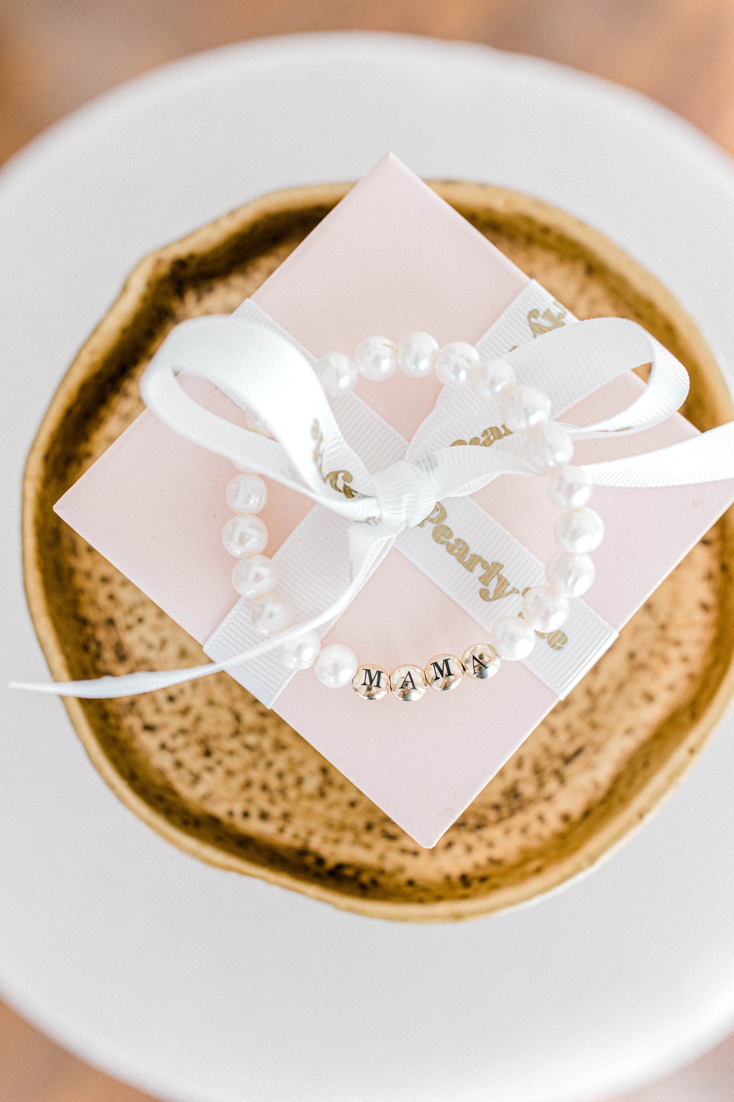 The perfect bracelet for all the mamas out there! This freshwater pearl bracelet can be made with gold letter beads or white letter beads.