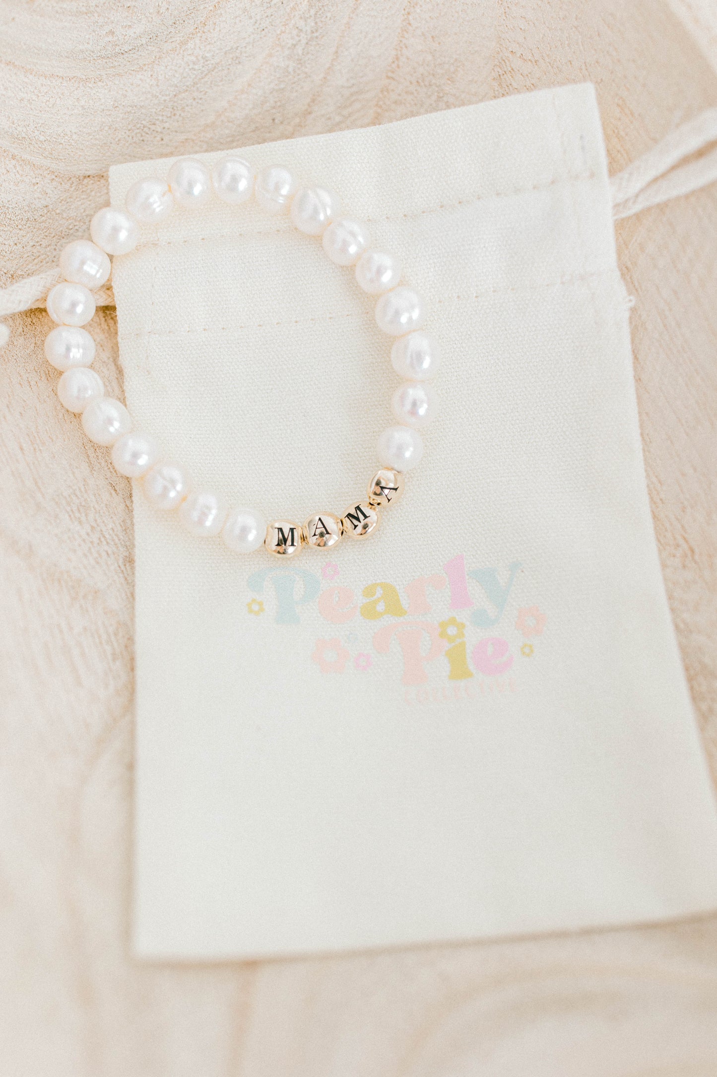 The perfect bracelet for all the mamas out there! This freshwater pearl bracelet can be made with gold letter beads or white letter beads.