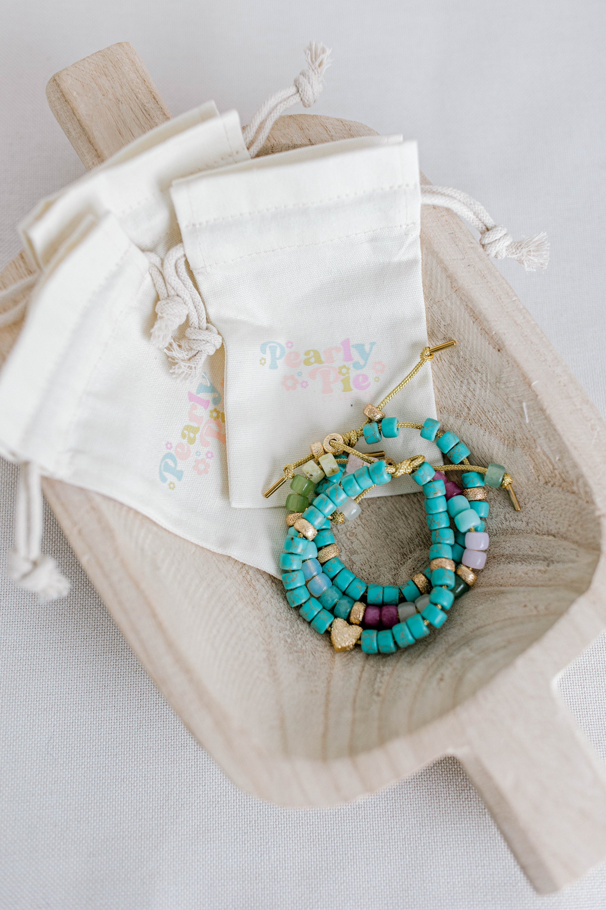 The perfect addition to your jewelry collection! This beautiful blue bracelet is made with forte gemstones and 18k gold filled stardust spacer beads that are strung on lurex cord with an adjustable sliding knot including a beautiful gold heart bead as a finishing touch. The blue forte beads have a gorgeous turquoise look to them for that lovely pop of blue.  This bracelet can be made with or without the heart bead.