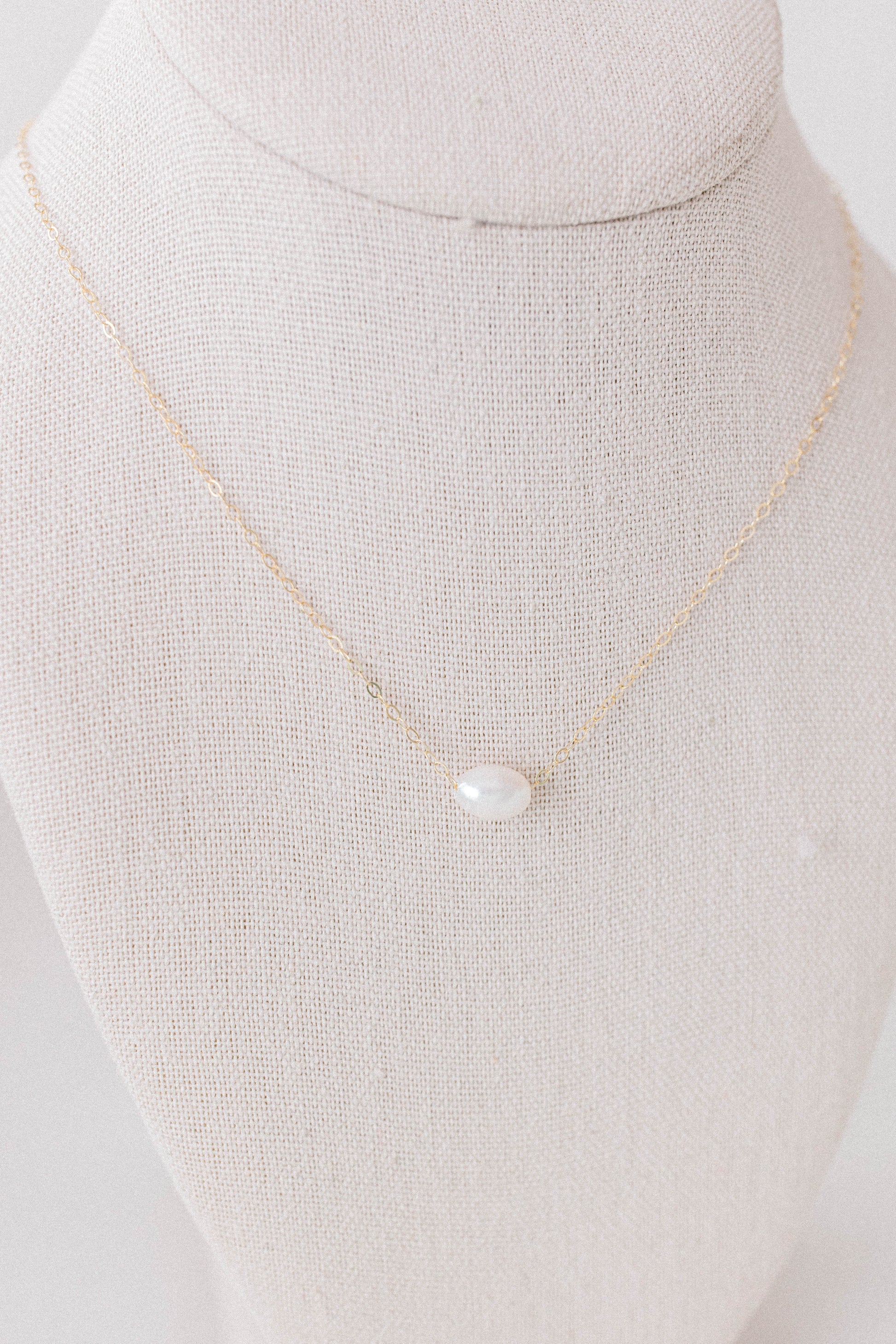 He Left the 99 jewelry collection necklace that is a 14k gold oval chain with a single pearl