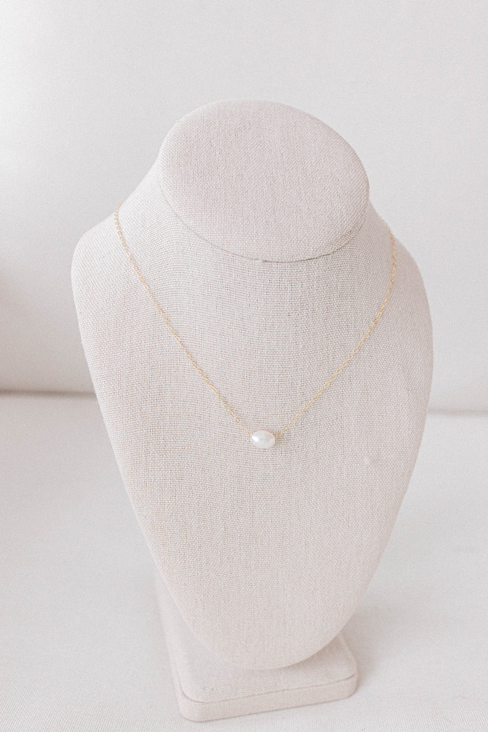 He Left the 99 jewelry collection necklace that is a 14k gold oval chain with a single pearl