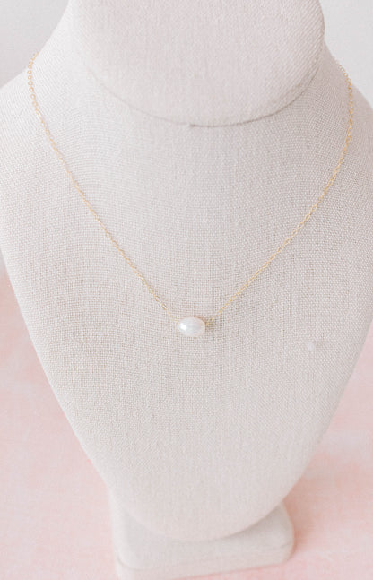 He Left the 99 jewelry collection necklace that is a 14k gold oval chain with a single pearl