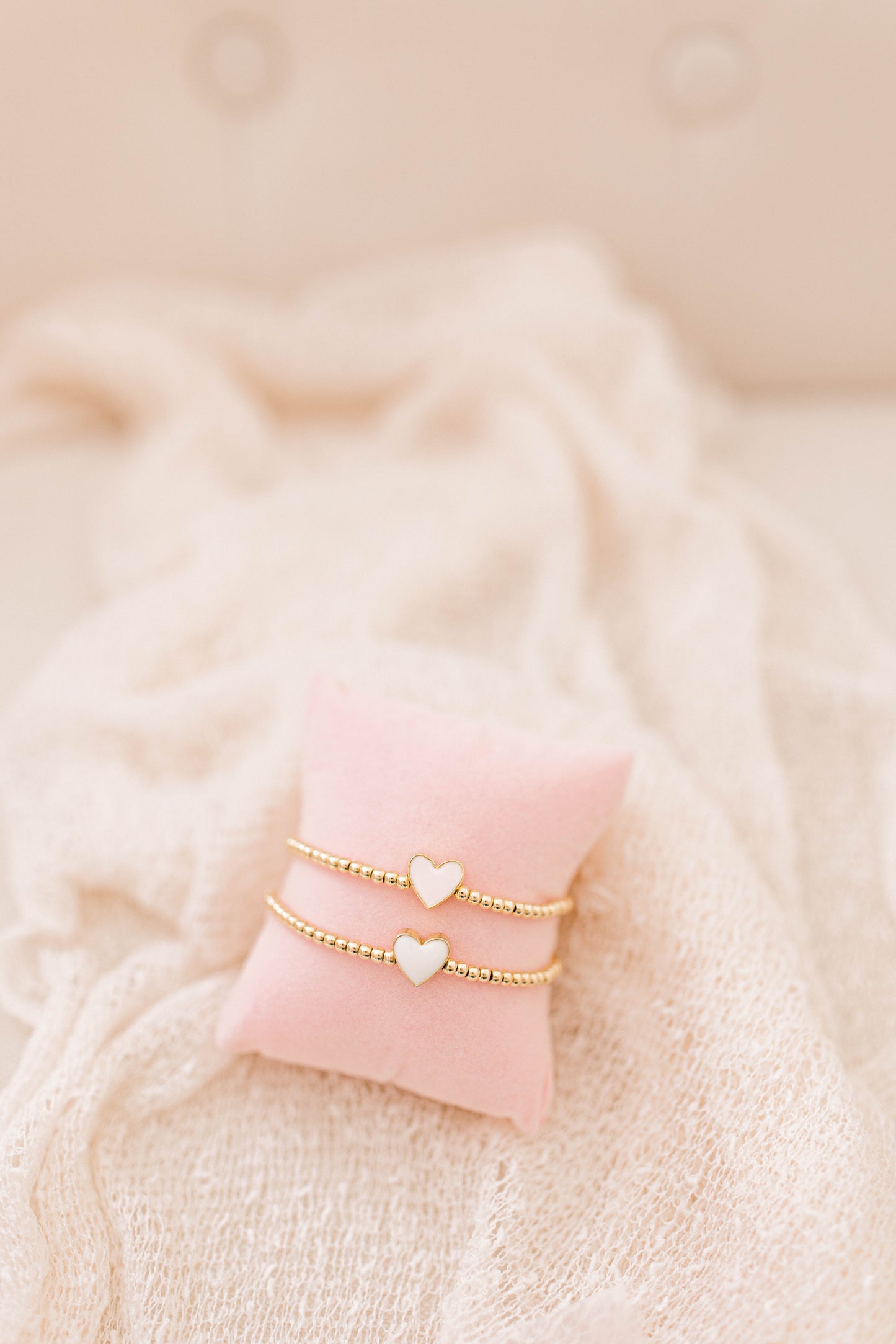 A simple and cute heart bracelet that goes with any outfit, day or night! 3mm 14K gold filled beads with a pink or white heart spacer bead!
