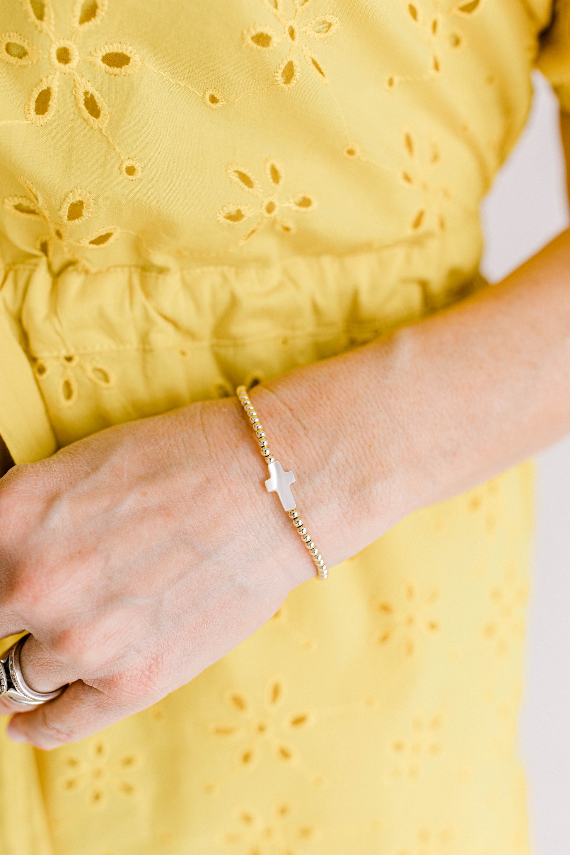 A beautiful cross bracelet perfect for gifting or loving yourself. 3mm 14K gold filled beads with a mother of pearl cross bead.