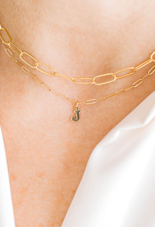 Sweet, simple, and filled with purpose! This necklace is a two layered 14K dainty gold filled paperclip chain with 14K gold filled letter charms on the  bottom layer and a 14K gold filled lobster clasp. The top layer of this paperclip necklace is larger while the second layer is dantier, adding depth to this gorgeous piece. This necklace is 15 inches with an optional 1, 2, or 3 inch extender. One initial per order. Letters A-Z available. If you'd like more initial tags, please reach out for a custom order!