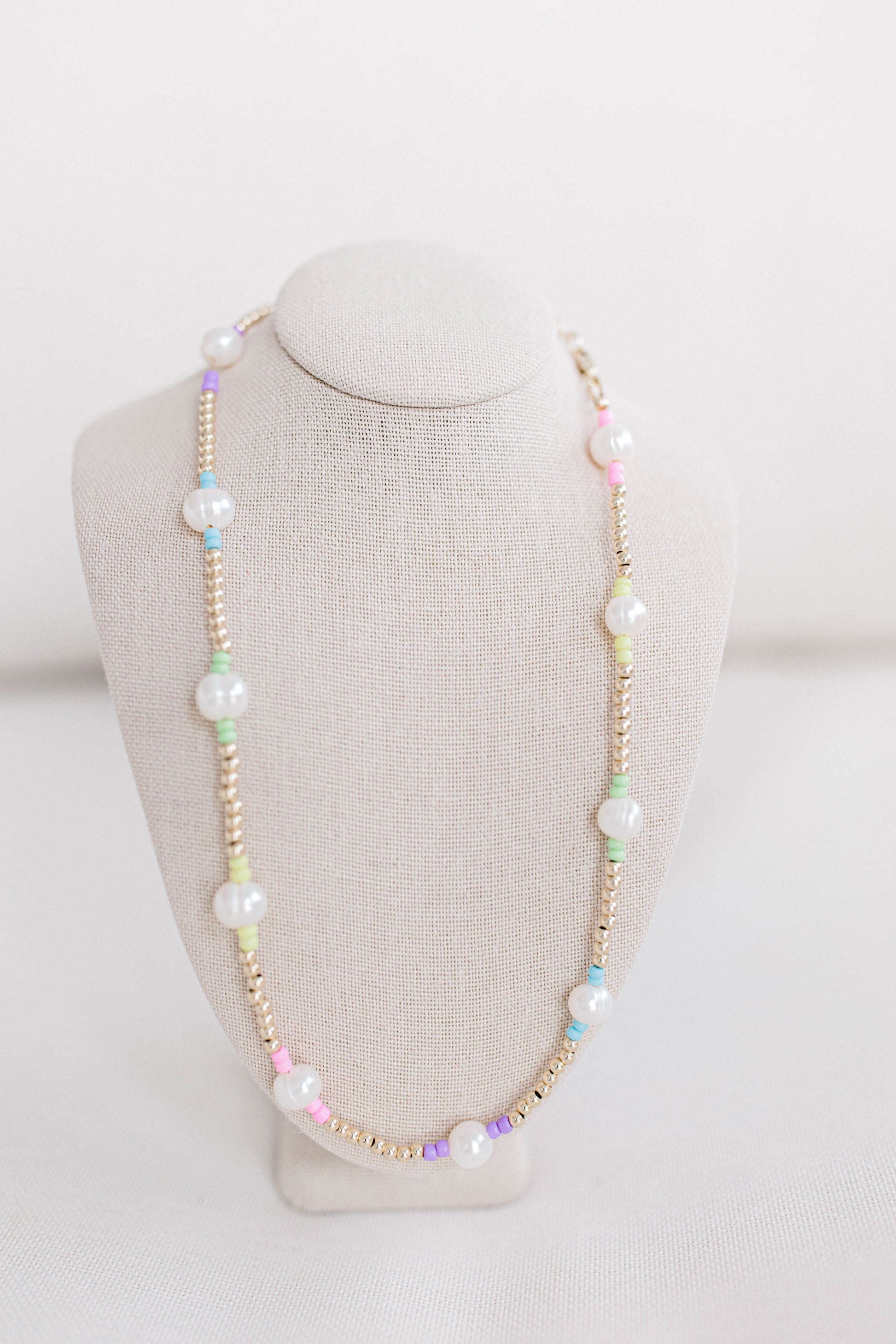 A cute multi-colored pastel seed bead necklace like our classic Pearly Pop necklaces and bracelets. This necklace is 15. in with 2 in. extender, fresh water pearls, seed beads, gold filled beads, gold filled clasp, and jump rings.