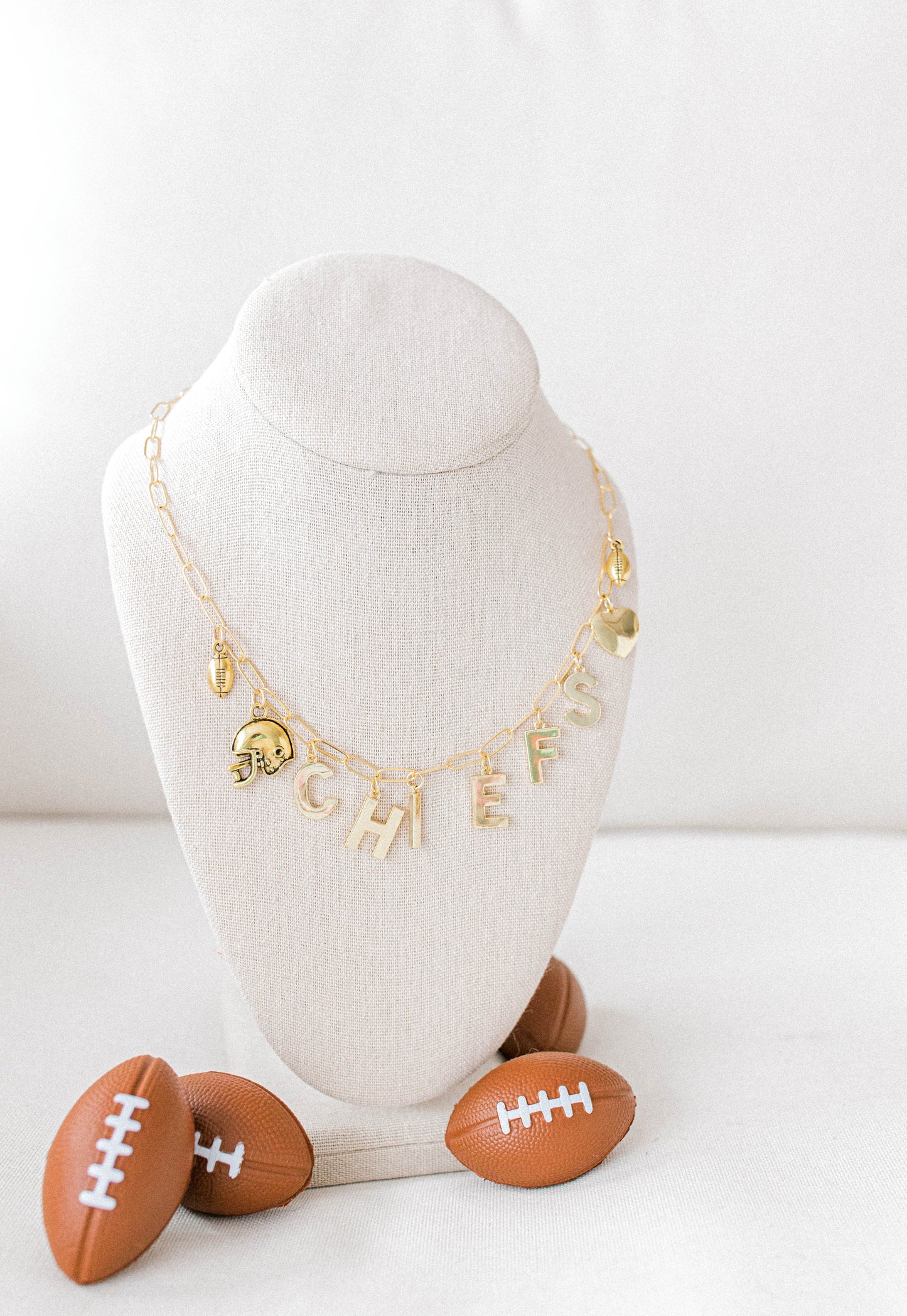 custom made 14k gold filled Chiefs charm necklace with football themed charms.