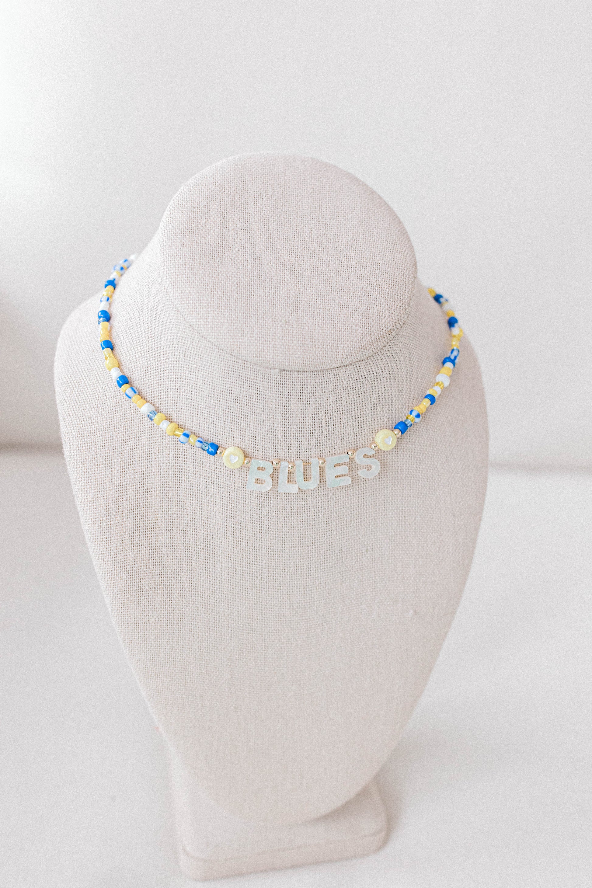 Custom seed bead necklaces with mother of pearl letters supporting your favorite sports team. All colors and letters available.