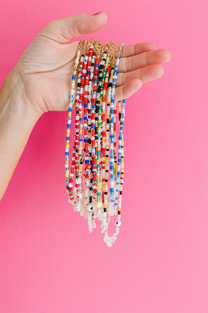 Custom seed bead necklaces with mother of pearl letters supporting your favorite sports team. All colors and letters available.