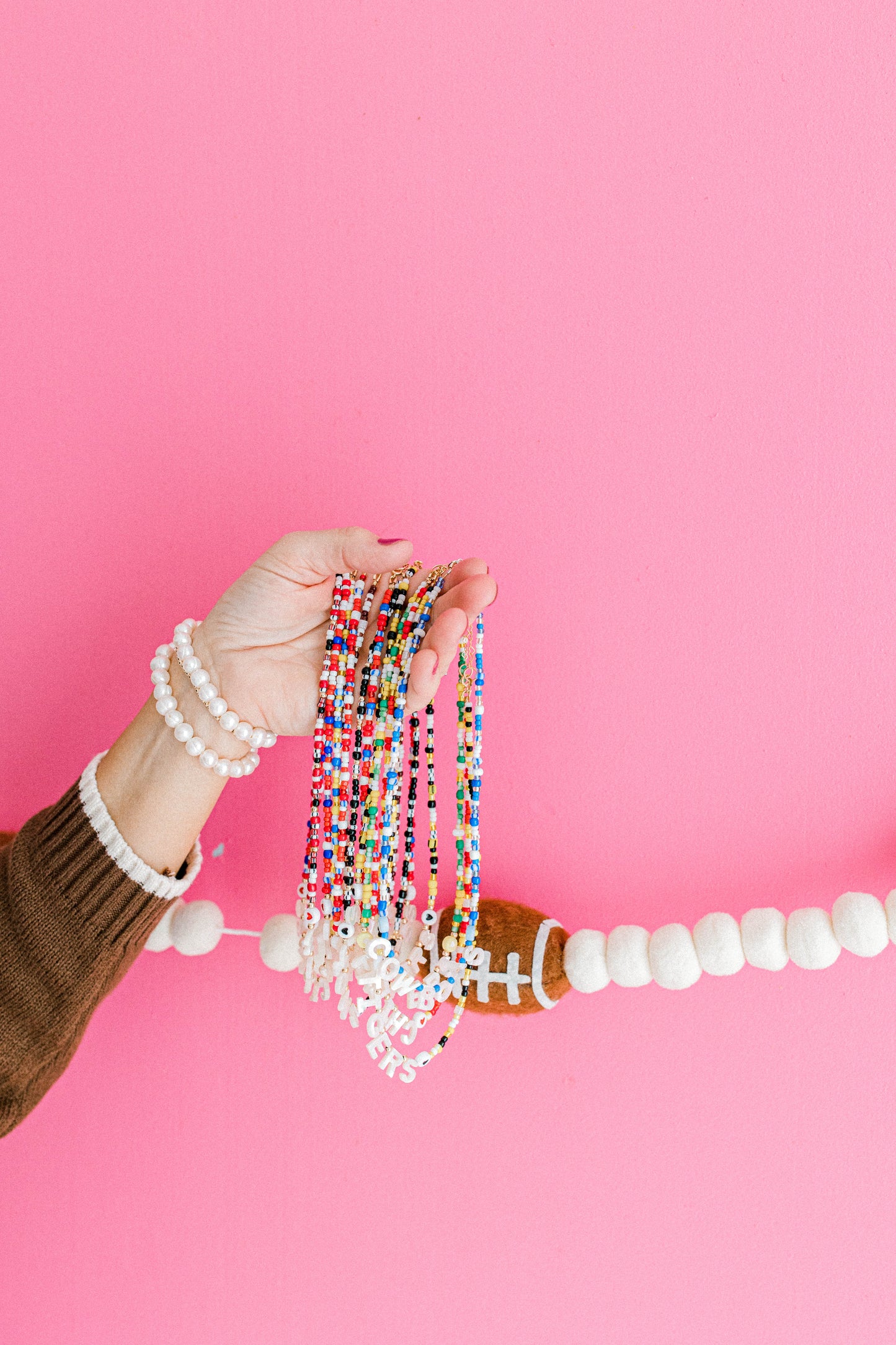 Custom seed bead necklaces with mother of pearl letters supporting your favorite sports team. All colors and letters available.