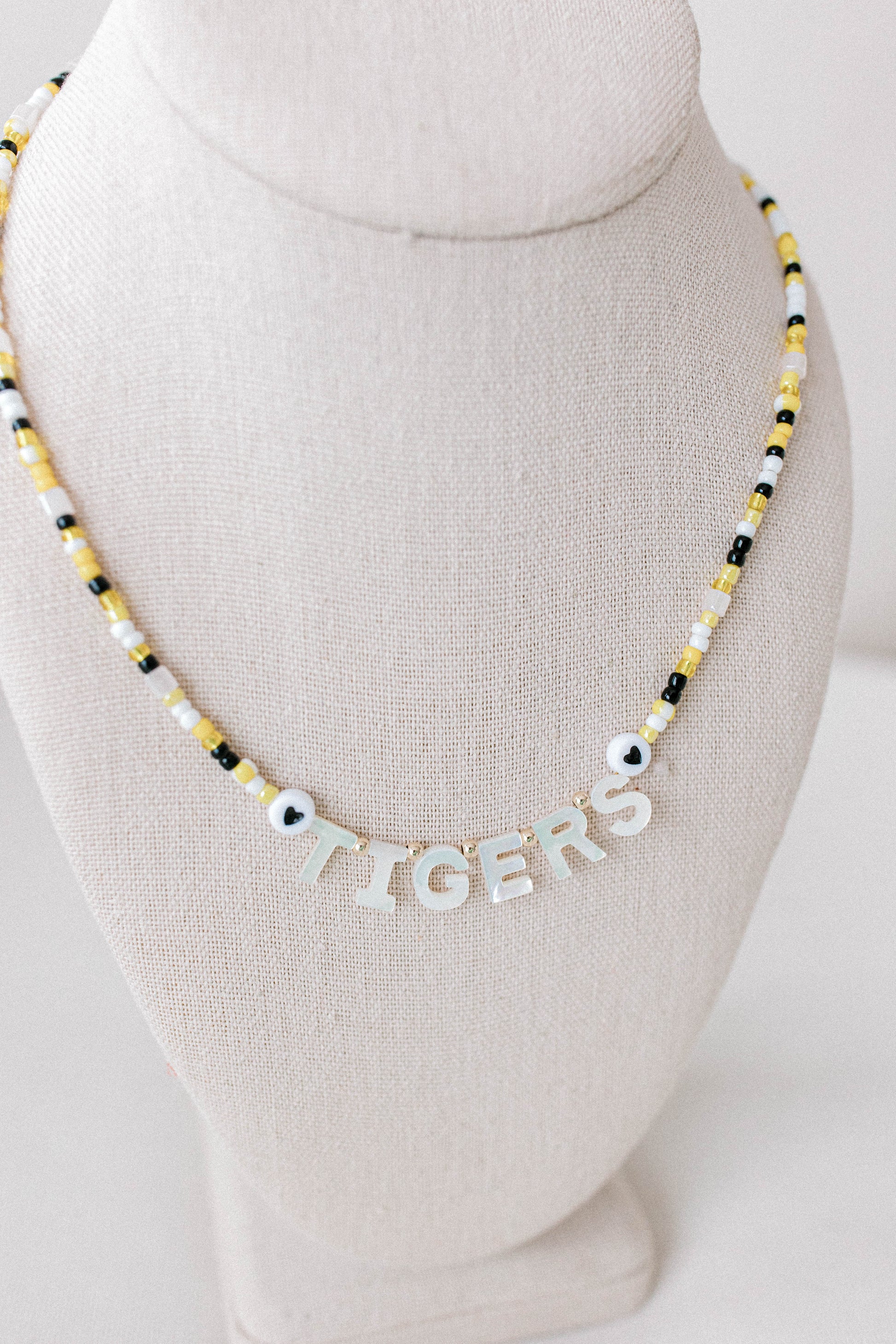 Custom seed bead necklaces with mother of pearl letters supporting your favorite sports team. All colors and letters available.