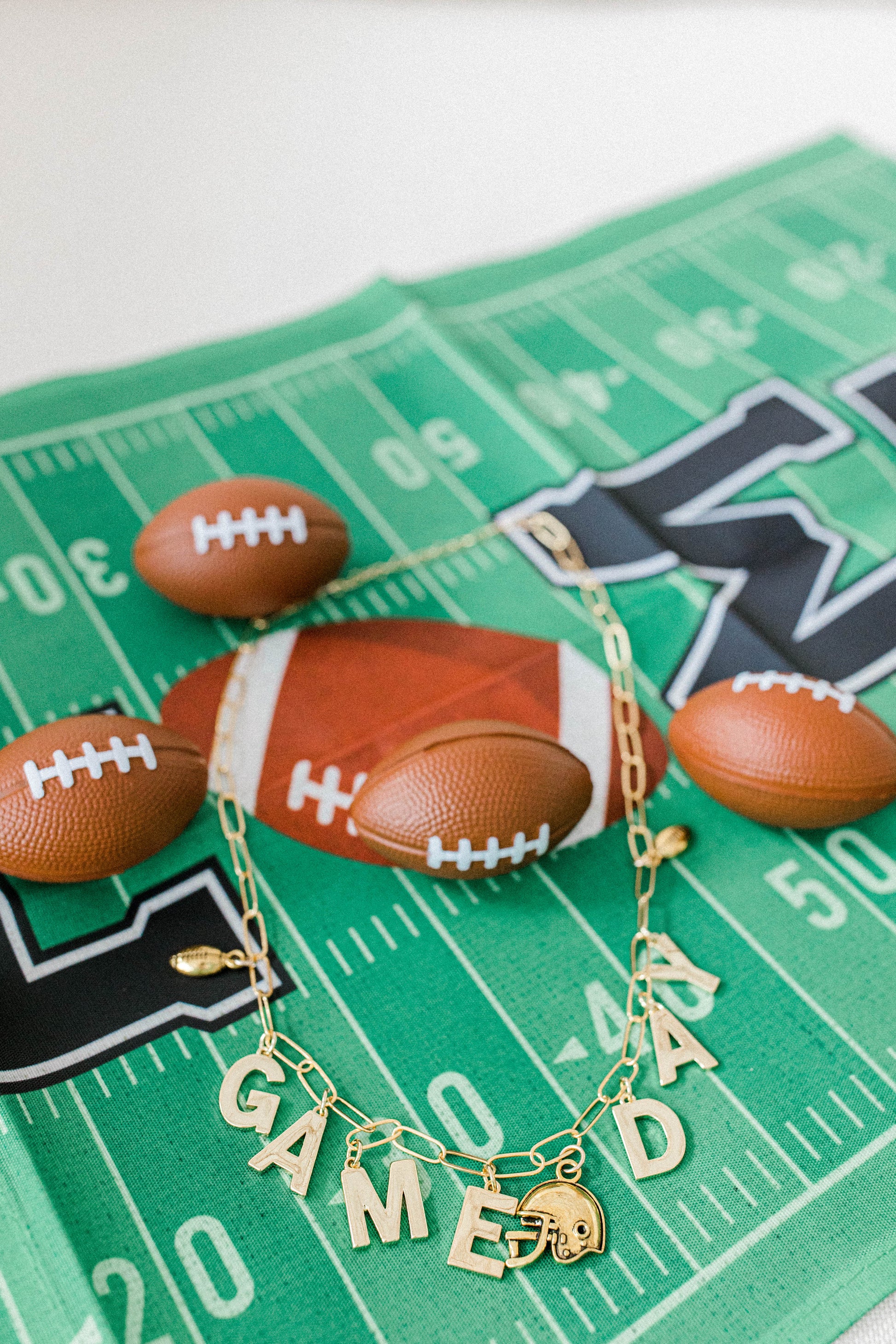 custom 14k gold filled charm necklaces spelling Game Day with football themed charms.