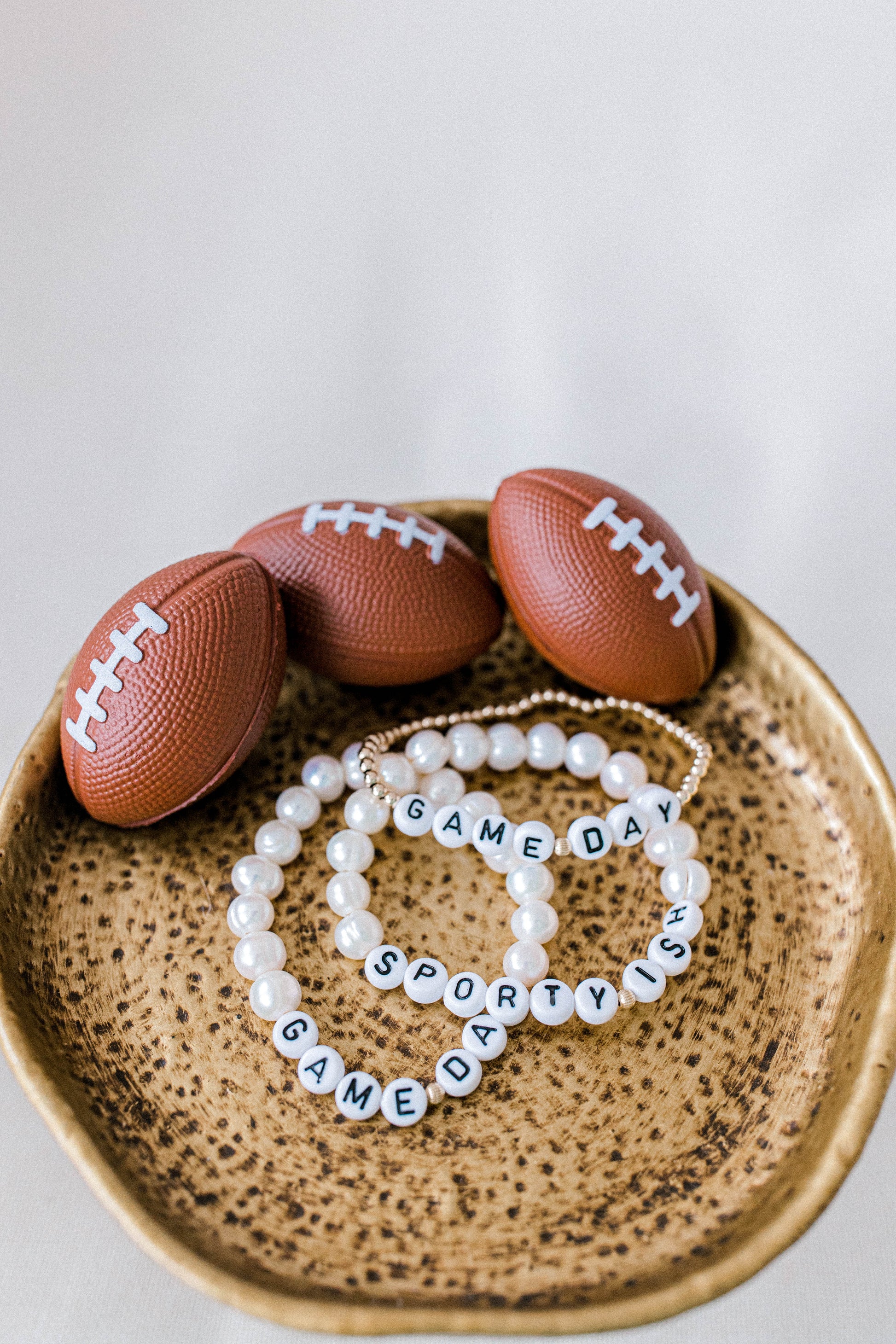 Pearly Pie Game Day Collection bracelets. 14k gold beaded game day bracelet with white letter beads and pearl beaded bracelets with white letter beads. Handmade using the highest quality materials.